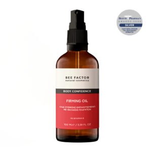 Fles Bee Factor Body Confidence Firming Oil van 100 ml met een zilveren Best in Pharmacy Awards 2026-badge.